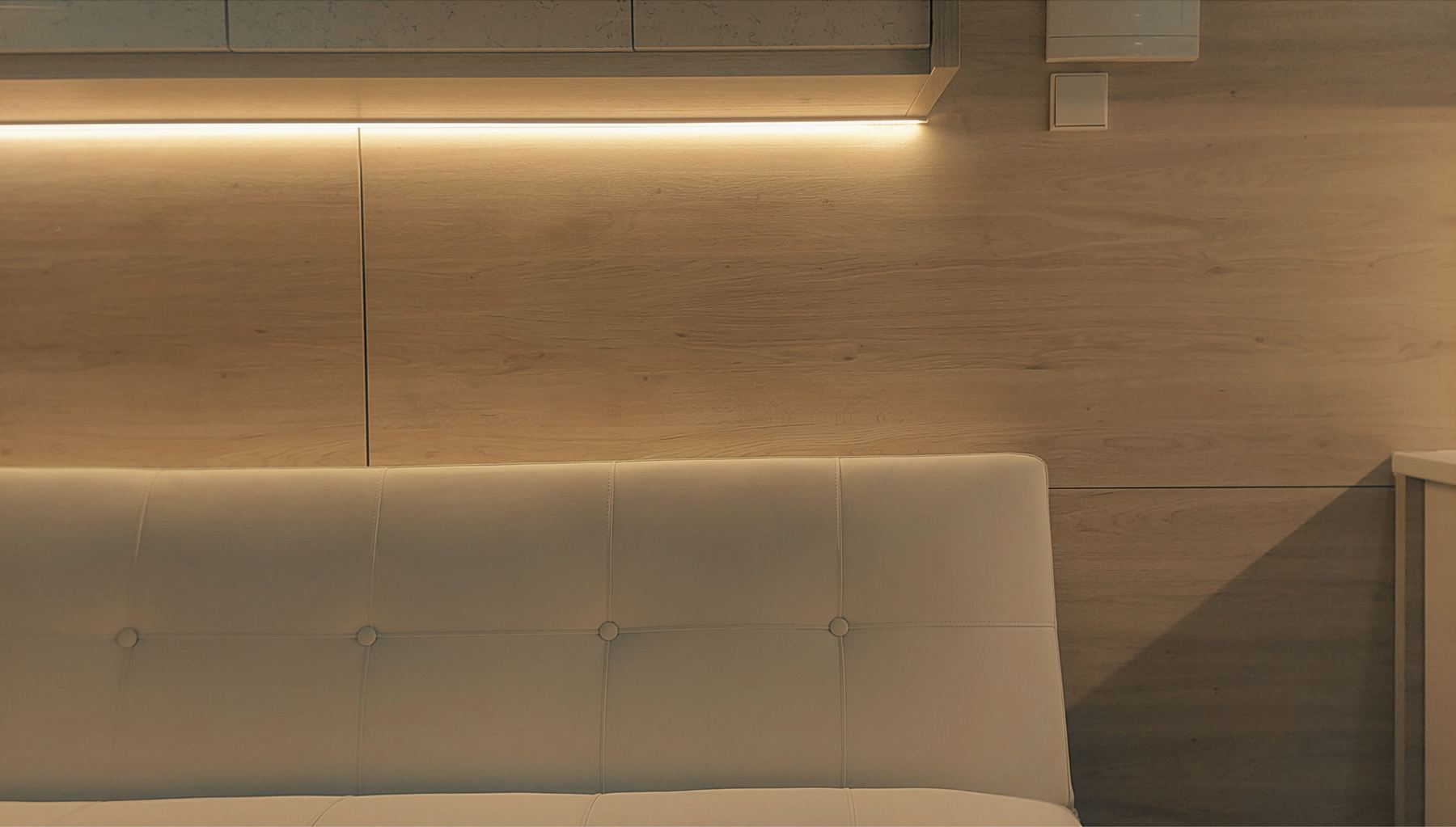 Sofà de Creixent amb la llum LED càlida sota els armaris